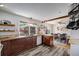 Bright kitchen featuring modern appliances, dark cabinets, open shelving and a large window view to the backyard at 3200 Eastman Ave, Boulder, CO 80305