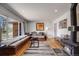 Inviting living room featuring a cozy wood-burning stove, hardwood floors, and a large window bench at 3200 Eastman Ave, Boulder, CO 80305