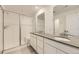 Modern bathroom featuring double vanity, frameless shower, and sleek fixtures at 6719 Juniper Dr, Thornton, CO 80602