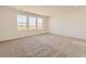 Spacious bedroom with large windows providing ample natural light and plush carpeting at 6719 Juniper Dr, Thornton, CO 80602
