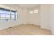 Bedroom featuring hardwood floors, a large window, and neutral paint at 6719 Juniper Dr, Thornton, CO 80602
