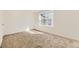 Bright, carpeted bedroom with large window offering natural light at 6719 Juniper Dr, Thornton, CO 80602