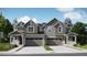 Charming duplex featuring stone accents, two-car garages, and inviting covered porches at 6719 Juniper Dr, Thornton, CO 80602