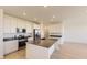 Modern kitchen featuring stainless steel appliances, kitchen island, and bright white cabinets at 6719 Juniper Dr, Thornton, CO 80602