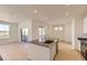 Open kitchen featuring large island with sink, stainless appliances, and natural light at 6719 Juniper Dr, Thornton, CO 80602