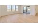 Bright open living room featuring hardwood floors, large windows, and sliding glass door at 6719 Juniper Dr, Thornton, CO 80602