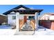 Charming craftsman home with a red door and snowy front yard at 3911 Vallejo St, Denver, CO 80211