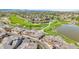 An aerial view of a residential area featuring a golf course, and a large lake at 3751 W 136Th Ave # F4, Broomfield, CO 80023