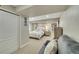 Bright bedroom with closet, floral bedding, neutral carpet, and comfortable seating area with soft lighting at 3751 W 136Th Ave # F4, Broomfield, CO 80023