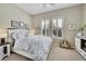 Bright bedroom with white wood bedframe, shuttered windows and neutral walls at 3751 W 136Th Ave # F4, Broomfield, CO 80023