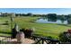 Inviting patio view overlooking pond, golf course, with colorful plants and outdoor decor at 3751 W 136Th Ave # F4, Broomfield, CO 80023