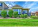 View of the home featuring mature landscaping, manicured lawn, and charming facade at 3751 W 136Th Ave # F4, Broomfield, CO 80023