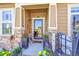 Inviting front entrance with a decorative door, stone accents, and vibrant potted plants creating curb appeal at 3751 W 136Th Ave # F4, Broomfield, CO 80023