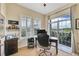 Well-lit home office with a lake view, shutters, and sliding door at 3751 W 136Th Ave # F4, Broomfield, CO 80023