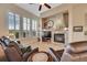 Cozy living room featuring a stone fireplace and large windows with plantation shutters at 3751 W 136Th Ave # F4, Broomfield, CO 80023
