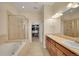 Bright main bathroom featuring dual sinks, a soaking tub, and a walk-in closet at 3751 W 136Th Ave # F4, Broomfield, CO 80023