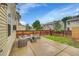 Backyard with concrete patio area, wooden fence, and lawn with patio furniture at 7946 S Kittredge St, Englewood, CO 80112