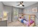 Cozy bedroom features a playful theme, light gray walls and a ceiling fan at 7946 S Kittredge St, Englewood, CO 80112