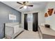 Comfortable bedroom with crib, dresser, and natural light, creating a cozy atmosphere at 7946 S Kittredge St, Englewood, CO 80112