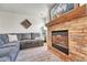 Cozy living room featuring a stone fireplace and comfortable sofa at 7946 S Kittredge St, Englewood, CO 80112