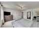 Spacious bedroom featuring bed, dresser, and television at 7946 S Kittredge St, Englewood, CO 80112