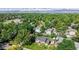 Aerial view of a residential neighborhood surrounded by lush green trees and mountain views at 6631 Welch Ct, Arvada, CO 80004