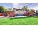 Landscaped backyard features a patio area, mature trees, and provides ample space for outdoor activities at 6631 Welch Ct, Arvada, CO 80004
