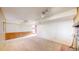 Spacious carpeted basement area with a brick fireplace and room for entertaining at 6631 Welch Ct, Arvada, CO 80004