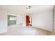 Spacious bedroom with mirrored closet doors and a view into an adjoining room at 6631 Welch Ct, Arvada, CO 80004