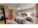 Serene bedroom featuring hardwood floors, a ceiling fan, and a cozy ambiance at 6631 Welch Ct, Arvada, CO 80004