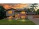Charming split-level home showcasing a well-maintained lawn, brick accents, and a welcoming entrance at 6631 Welch Ct, Arvada, CO 80004