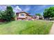 Charming front yard with fresh green grass, mature trees, and a well-maintained lawn at 6631 Welch Ct, Arvada, CO 80004