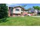 Attractive two-story home with brick and siding facade, professional landscaping, and a spacious front yard at 6631 Welch Ct, Arvada, CO 80004