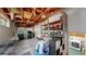 Unfinished garage interior with overhead storage, shelving, and a garage door at 6631 Welch Ct, Arvada, CO 80004