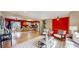Spacious living area showcasing hardwood floors, neutral paint, and seamless flow to kitchen at 6631 Welch Ct, Arvada, CO 80004