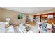Open-concept living space with hardwood floors, leading to a modern kitchen and dining area at 6631 Welch Ct, Arvada, CO 80004