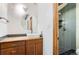 Modern bathroom features a vessel sink, wood vanity and tiled shower with black hexagon floor tiles at 11155 Kennedy Ave, Conifer, CO 80433