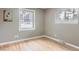 Cozy bedroom features hardwood floors, windows with views of the surrounding woods and a picture hanging on the wall at 11155 Kennedy Ave, Conifer, CO 80433