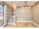 Inviting dining area with neutral walls, hardwood floors, and ample natural light from a large window at 11155 Kennedy Ave, Conifer, CO 80433