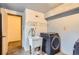 Functional laundry room with new washer, sink, and shelving, providing convenience and storage at 11155 Kennedy Ave, Conifer, CO 80433