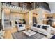 Inviting living room with high ceilings, a cozy sofa, and a neutral color palette, perfect for relaxation at 11155 Kennedy Ave, Conifer, CO 80433