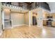 Open-concept living and dining area with hardwood floors, stairs and plenty of natural light at 11155 Kennedy Ave, Conifer, CO 80433