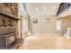 Cozy living room with a stone fireplace, hardwood floors, and bright natural light, creating a warm ambiance at 11155 Kennedy Ave, Conifer, CO 80433