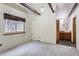 Bright main bedroom featuring hardwood floors, exposed beams, and en-suite bathroom at 11155 Kennedy Ave, Conifer, CO 80433