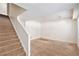 Finished basement features carpeted stairs and open area, ready for customization at 20108 Randolph Pl, Denver, CO 80249