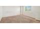 Spacious bedroom with a large window provides ample natural light and street views at 20108 Randolph Pl, Denver, CO 80249