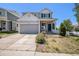 Charming two-story home with a well-manicured lawn and inviting front porch and attached two car garage at 20108 Randolph Pl, Denver, CO 80249