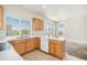 Well-lit kitchen equipped with essential appliances and ample countertop area with bar stool seating at 20108 Randolph Pl, Denver, CO 80249