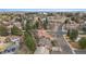Aerial view of a neighborhood with mature trees and landscaping with open green spaces and a pond at 11545 Quivas Way, Westminster, CO 80234
