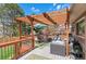 Inviting back deck with wood pergola, outdoor seating, and space for dining and entertaining at 11545 Quivas Way, Westminster, CO 80234